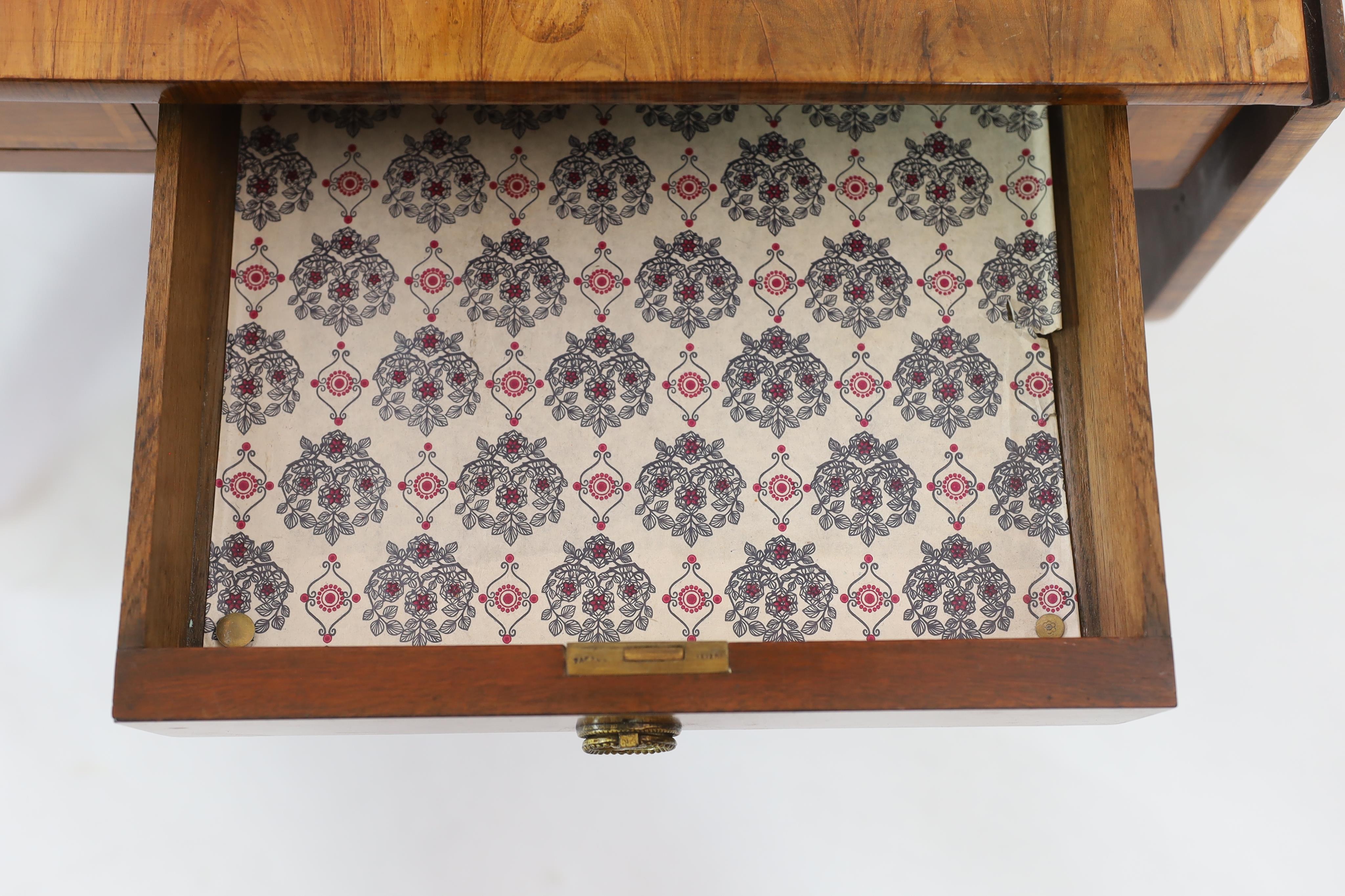 A Regency satinwood banded mahogany sofa table, with two frieze drawers on end standards with turned stretcher and downswept legs, fitted brass castors, width 80cm, depth 64cm, height 71cm. Condition - fair